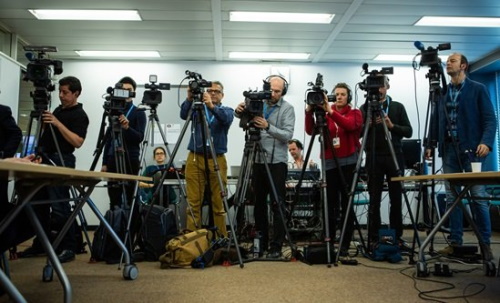 Camera men surrounding a speaker